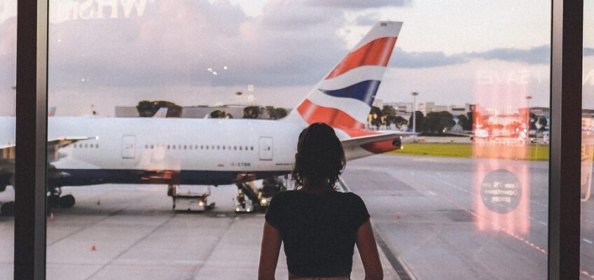 A woman looking at the airport runway