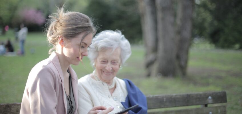 a woman using phone with her mother