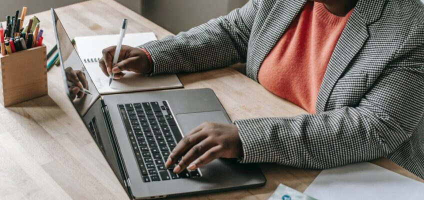 a woman is busy on her laptop