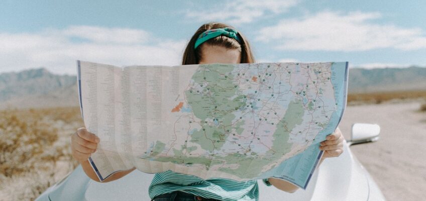 woman holding a map in a desert setting