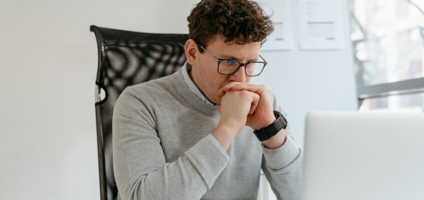 man staring at his laptop