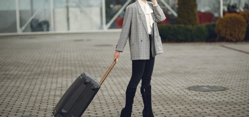 woman talking on smartphone with suitcase