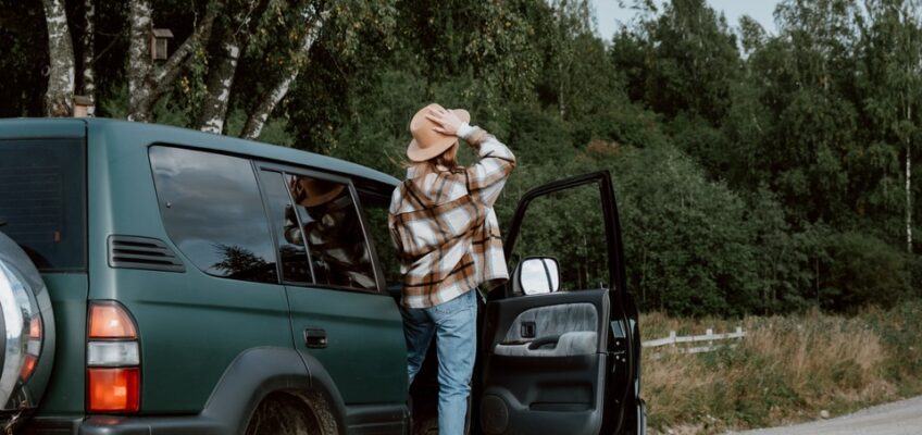 person standing on a passenger side of a car