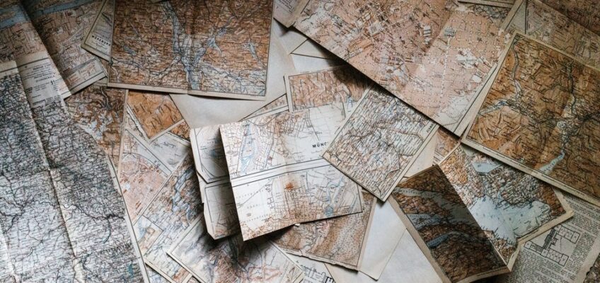 Folded maps scattered on the floor.