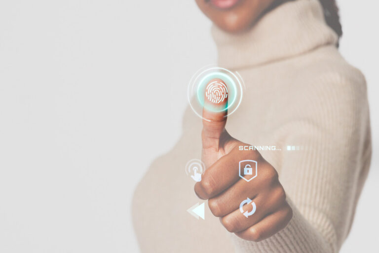 A person interacting with a futuristic holographic interface, focusing on a fingerprint scan to symbolize advanced biometric security measures.