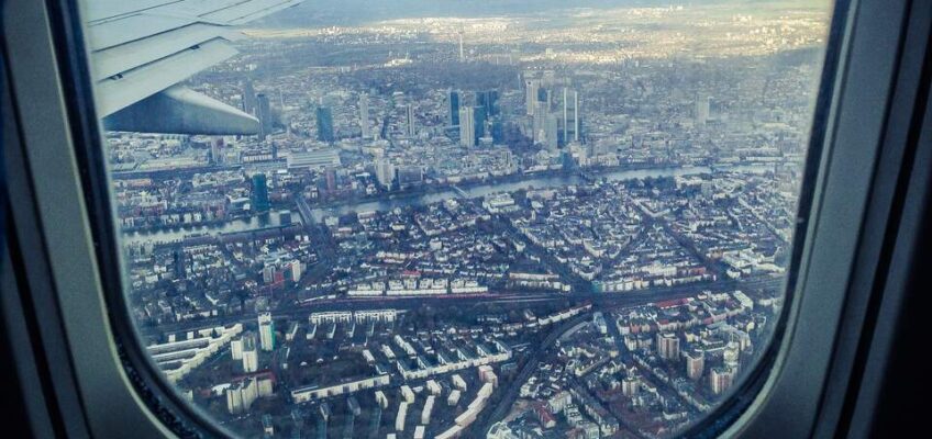 A view of a city from inside of an airplane