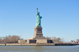 Statue of Liberty on Liberty Island against a clear blue sky, symbolizing U.S. travel and the gateway for ESTA visa waiver program participants.