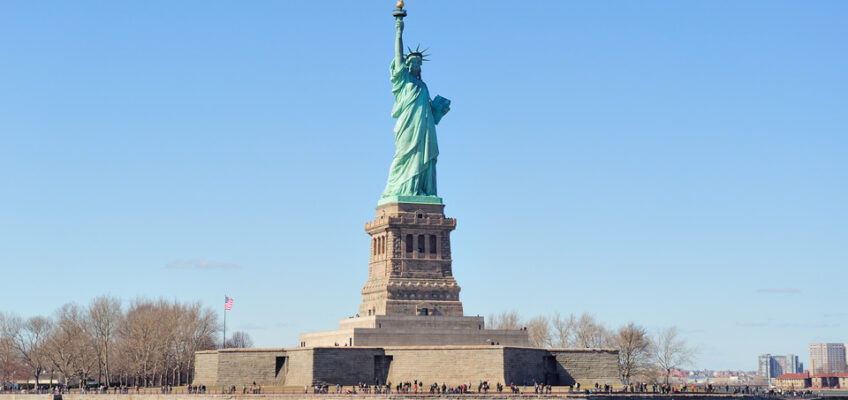 Statue of Liberty on Liberty Island against a clear blue sky, symbolizing U.S. travel and the gateway for ESTA visa waiver program participants.