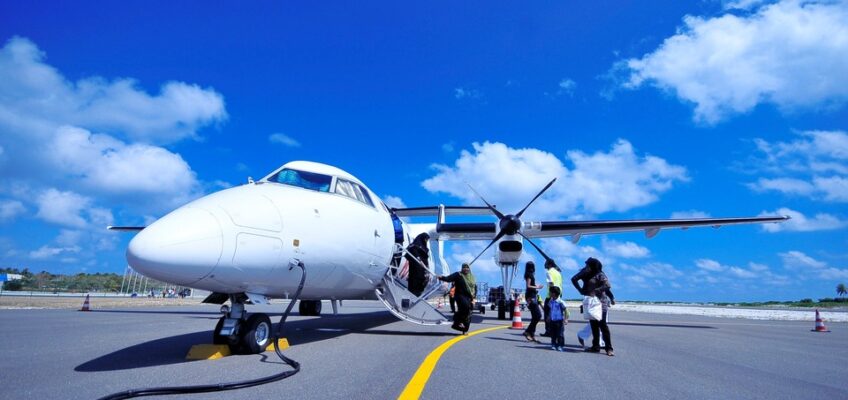 Passengers boarding a private jet on a sunny tarmac, symbolizing the upscale travel subject to Turkish eVisa regulations.