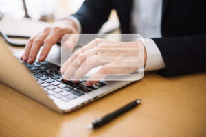 Person logging into a secure online account on a laptop, highlighting the importance of data privacy for U.S. ESTA applications.